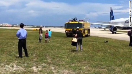 Passenger aboard an American Airlines plane captured video of their flight as it was evacuated at Palm Beach International airport in Florida.