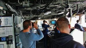 NOAA Commissioned Officers and Third Mate Carl VerPlanck of the Deck Department navigate NOAA Ship Rainier