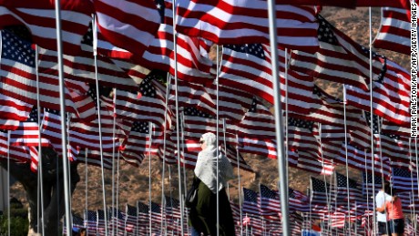 A woman wearing a hijab stands amongst US national flags erected by students and staff from Pepperdine University as they pay their respects to honor the victims of the September 11, 2001 attacks in New York, at their campus in Malibu, California on September 10, 2016. 
The students placed aound 3,000 flags in the ground in tribute to the nearly 3,000 victims lost in the attacks almost 15 years ago.  / AFP / Mark RALSTON        (Photo credit should read MARK RALSTON/AFP/Getty Images)