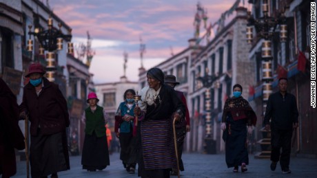 TOPSHOT - This picture taken on September 11, 2016 shows pilgrims walking and praying near the Jokhang Temple in the regional capital Lhasa, in China&#39;s Tibet Autonomous Region. / AFP / JOHANNES EISELE        (Photo credit should read JOHANNES EISELE/AFP/Getty Images)