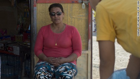 Raja Paulous, 46 (in the middle) talks to neighbors sitting at the entrance of her grocery shop in the Ankawa 2 Camp where she lives with her family since 2014 when they were forced to flee their home in Qaraqosh as Islamic State advanced.
Erbil, Iraq. 