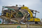 An excavator with a shear attachment performs “top-down” shearing during final stages of the demolition of the C-410/C-420 UF6 Feed Plant Complex in June. Demolition debris was downsized and loaded into rail cars for shipment off site. The complex was the last of 32 inactive facilities to be removed as part of the cleanup scope that existed before commercial uranium enrichment operations ended at the Paducah Gaseous Diffusion Plant and the plant facilities were returned to DOE. (Photo by Dylan Nichols)