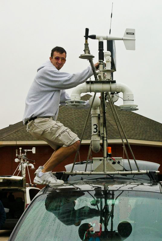 Sean Waugh adjusts equipment on mobile mesonet