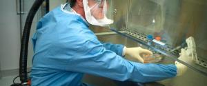 Centers for Disease Control's (CDC) staff microbiologist extracting a reconstructed 1918 Pandemic Influenza virus.
