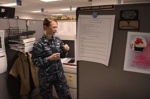 Hospital Corpsman 1st Class (FMF) Aimee Granger, a Hospital Corpsman detailer with Navy Personnel Command's (NPC) Career Management Department, and NPC's Sailor of the Year, helps a Sailor with a detailing issue.