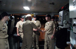 Rear Admiral De Bow handing the Command Coin to Commander Noll