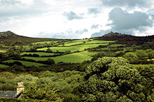 Green hills with trees in the foreground.