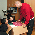 Man with children packing boxes