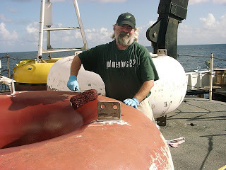Rick painting the buoy