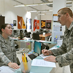 Service members talking at desk
