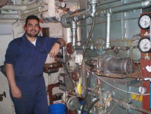 Jake DeMello stands by the desalination machine in the Miller Freeman’s engine room. 
