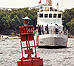 A boat approaching a buoy