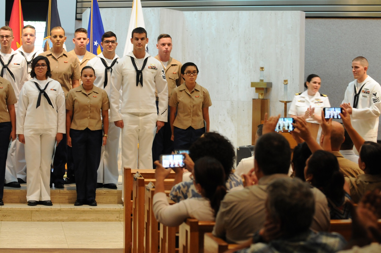 PENSACOLA, Fla. (Sept. 1, 2015) Family and friends snap photos of students graduating from the Communications Signals Collection and Processing Course at the Center for Information Dominance Unit Corry Station.  Trained to join the Information Dominance Corps, cryptologic technicians (collection) serve as experts in intercepting signals. (U.S. Navy photo by Carla M. McCarthy 