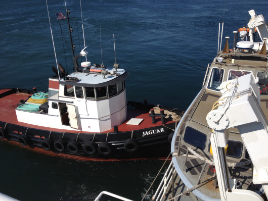 The tugboat Jaguar helping the TJ dock at Newport