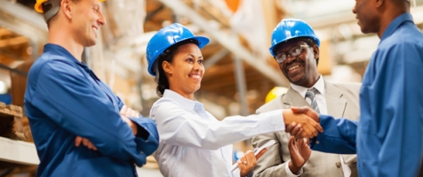 warehouse manager shaking hands with warehouse worker