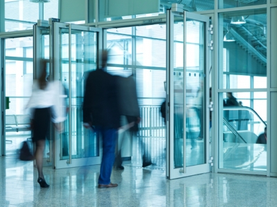 People Walking Through Entrance Door