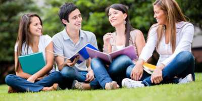 High school students sitting on lawn