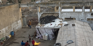 Syrian refugees live in a factory bombed by the Israeli military in 1982 near Faida, Lebanon. Photo Courtesy of The New York Times/ Lynsey Addario