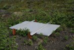 'The above ground view of the seismic station in Sand Point, AK.  Seismic stations are generally buried underground and well insulated.  The slightest air movement or sudden temperature changes can affect the quality of the data.'