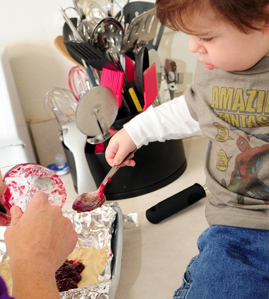 Little boy helping parent bake.