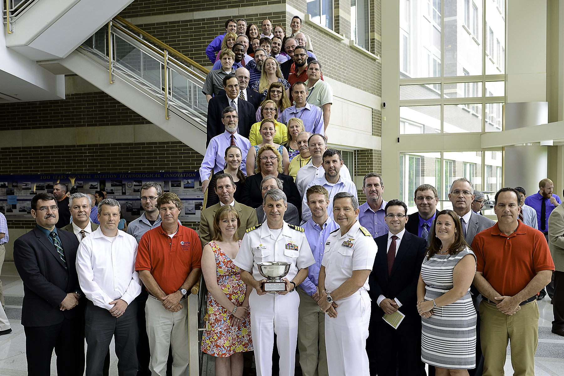 Members from the Unmanned Carrier Launched Airborne Surveillance and Strike (UCLASS) receive a Naval Air Systems Command (NAVAIR) Commander’s Award in the program management category during a ceremony held June 17 at NAS Patuxent River. Photo courtesy of U.S. Navy.