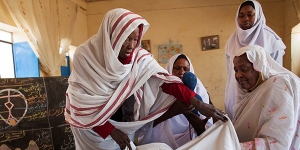 El Fasher: (Furthest left and furthest right) Teachers Nephisa Ahmed and Hawa Osmani show (center left to right) students Ihlas Mohamed and Manahil Adam how to assist a delivery at the lab of the Midwifery School in El Fasher, North Darfur. Teachers and students of this center recently signed a pledge to stop the practice of female genital mutilation in Darfur.  Photo by Albert Gonzalez Farran, UNAMID.