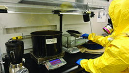 	person in a hazmat suit in a lab