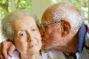 Senior man kissing wife on cheek