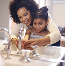 Woman and child washing their hands