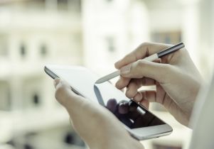 A woman using tablet with stylus pen