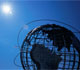 Metal sculpture of the globe against a bright blue sky