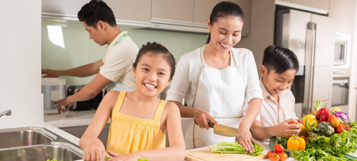 Happy Vietnamese family cooking dinner together