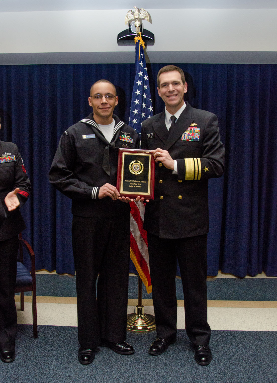 WASHINGTON (Jan. 29, 2015) Vice Admiral Dixon R. Smith (right), Commander, Navy Installations Command (CNIC) presents Air-Traffic Controlman 1st Class (AW/SW) Darren S. Johnson (left), from Naval Station (NAVSTA), Norfolk, Va., under Navy Region Mid-Atlantic, with a plaque for selected as the 2014 CNIC Sailor of the Year.  An award ceremony was held at CNIC headquarters at the historic Washington Navy Yard on Jan. 29. U.S. Navy photo by Sandra Niedzwiecki.