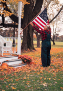 Man with flag at house