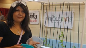 Gabriela Hernandez shows off cucumber plants and fish food