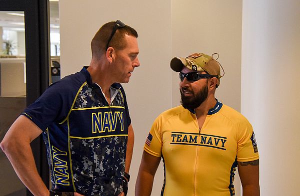 WASHINGTON (Oct. 11, 2016) Commander, Navy Installations Command, Vice Adm. Dixon Smith, speaks with retired Navy Petty Officer 2nd Class Adrian "AJ" Mohammed before a 17-mile fun ride that started and ended at the Washington, D.C.'s historic Navy Yard. Smith, riding on a tandem bike with Mohammed, served as pilot for the retired petty officer. Mohammed's combat injuries left him visually impaired, and cycling has created new challenges and opportunities. U.S. Navy photo by Petty Officer 1st Class John Belanger.