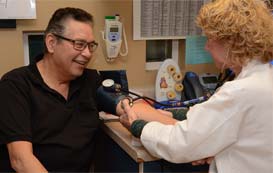 Man having blood pressure taken by doctor