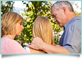 Parents comfort their teen daughter. 