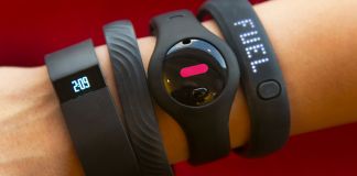 Fitness trackers on an arm (© AP Images)