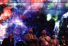 People looking up into image of space (© AP Images)