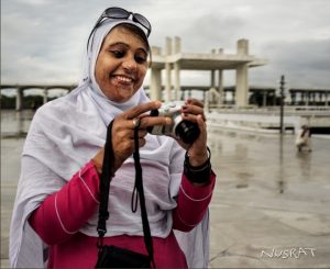 Nusrat Bibi, an acid burn survivor, takes photographs during a field trip for a photography workshop. / Diego Sanchez, USAID