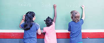 Children using a chalkboard