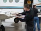 Pilots from Weather Modification, Inc., prepare the cloud seeding aircraft with seeding flares.