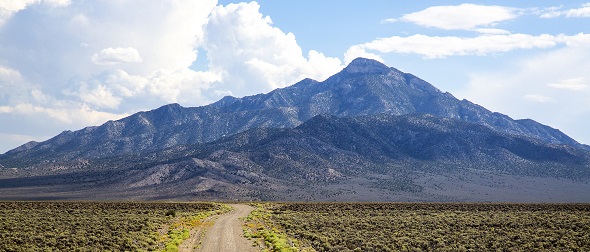 A landscape view of a road leading to a mountain in Basin and Range National Monument. Photo by Bob Wick, BLM.