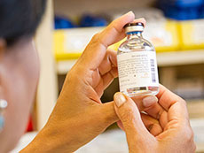 Pharmacist Examining a Drug Vial