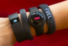 Fitness trackers on an arm (© AP Images)