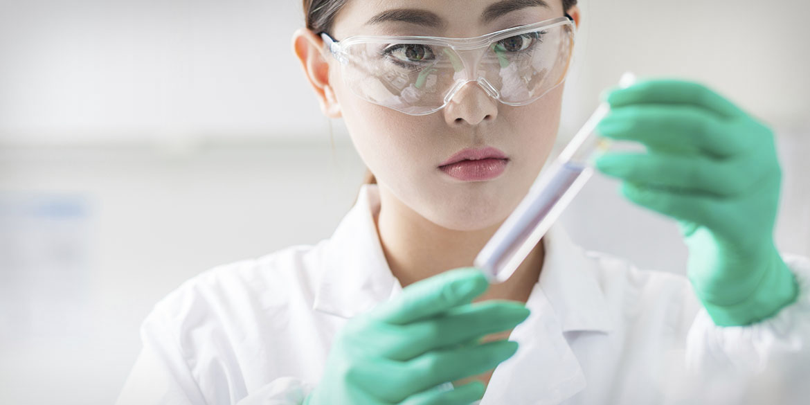 A woman researcher filling a syringe.