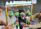 A teacher helps students perform a science experiment at Kavi Kalidas Primary School.