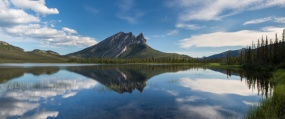 Sukakpak Mountain and its reflection in a clear blue lake on summer day along the Dalton Highway cooridor