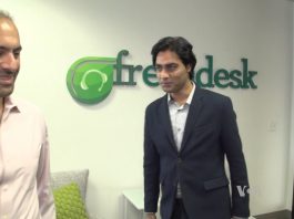 Two people in front of freshdesk logo (VOA)